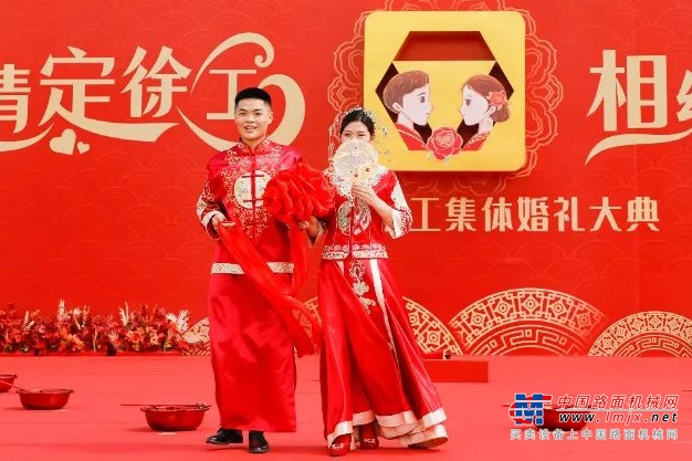 仪式上，包括全球最大马力矿用平地机GR5505在内的数百台国之重器列队“送嫁”。26对新人相识相爱的经历、温馨日常的小故事缓缓讲述，掌声与欢呼交融，笑容与泪水相伴。迈火盆、跨马鞍、登喜台、拜堂交杯，幸福羞涩的笑容在每一对新人脸庞久久不散。