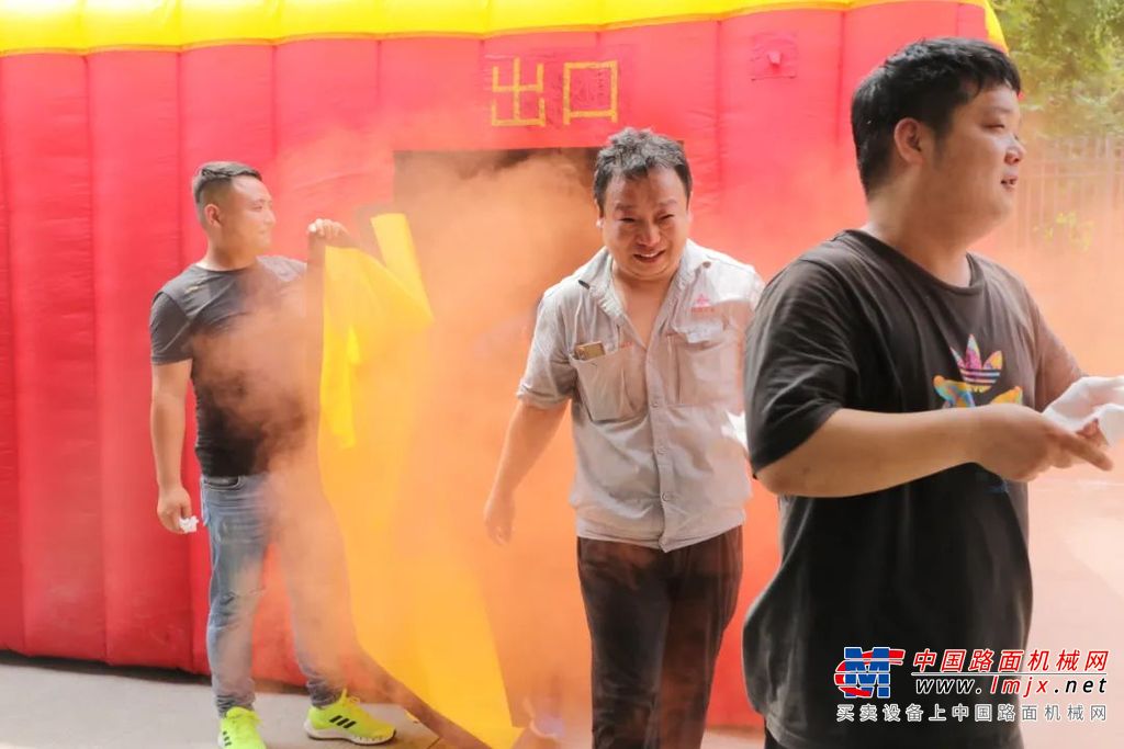 “消防疏散逃生体验屋” 只设进出两个门口，进出口上带有遮光用的门帘，内部设有“隔断墙”，障碍、浓烟等，通过模拟道路不清、视线受限、呼吸受阻等场景，在黑暗的空间内释放无害烟雾、播放火场音效，营造出浓烟弥漫的效果，最大程度模拟火灾现场，实现了实景逃生演练的效果。老师现场宣讲火灾疏散事项和应急逃生技巧后，员工进入“体验屋”亲身体验。